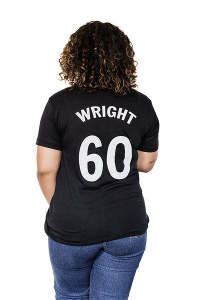 Back of Black female model wearing a Richard Wright #60 black unisex tee