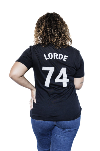 Back of Black female model wearing Audre Lorde #74 black unisex baseball tee
